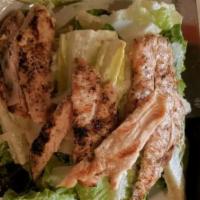 Chicken Caesar Salad · Grilled free range chicken breast, organic romaine, dressing, and shaved parmesan.