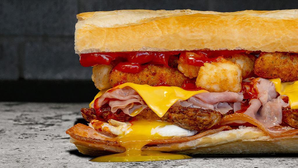 Fat Breakfast. · Fried Eggs | Ham | Crisp Bacon | Breakfast Sausage | Mozzarella Sticks | Melted American | Tots | Ketchup | 
Tapatío | On A Butter Grilled Hero