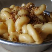 Mac N' Cheese · Cavatappi pasta, house-made worcestershire cheese sauce, topped with corn bread crumbs.