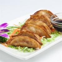 Gyoza · Fried dumplings filled with ground chicken, cabbage and scallion served with sweet soy sauce...