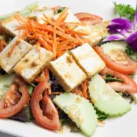 House Salad · Spring mix salad, tomato, cucumber, carrot and tofu served with peanut sauce dressing.