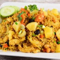 Pineapple Fried Rice · Fried rice with your choice of meat, egg, pineapple, tomatoes, onions, scallions, raisins, p...