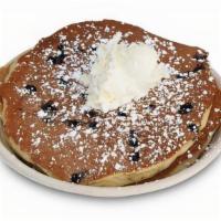 Blueberry Pancakes · Three Classic buttermilk pancakes made with fresh 
blueberries, powdered sugar, whipped butt...