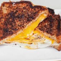 Grown Up Brekkie Melt · Two fried eggs, melty Cheddar, mozzarella and Jack cheeses between two sliced of buttery gri...
