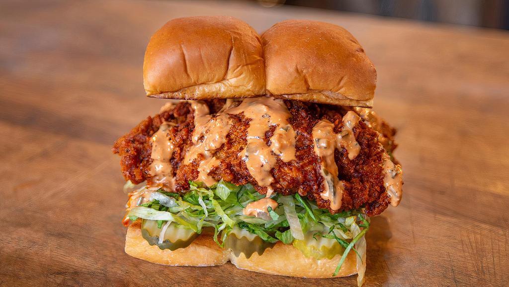 Hot Chick · Two crispy fried chicken tenders, spiced to your liking, Plain, Nashville Hot or Nashville Hotter with secret sauce, dill pickle slices and haus slaw; served on Kings Hawaiian rolls