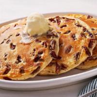 Pecan Pancakes – Three · Three Buttermilk Pancakes n’ butter with pecans.