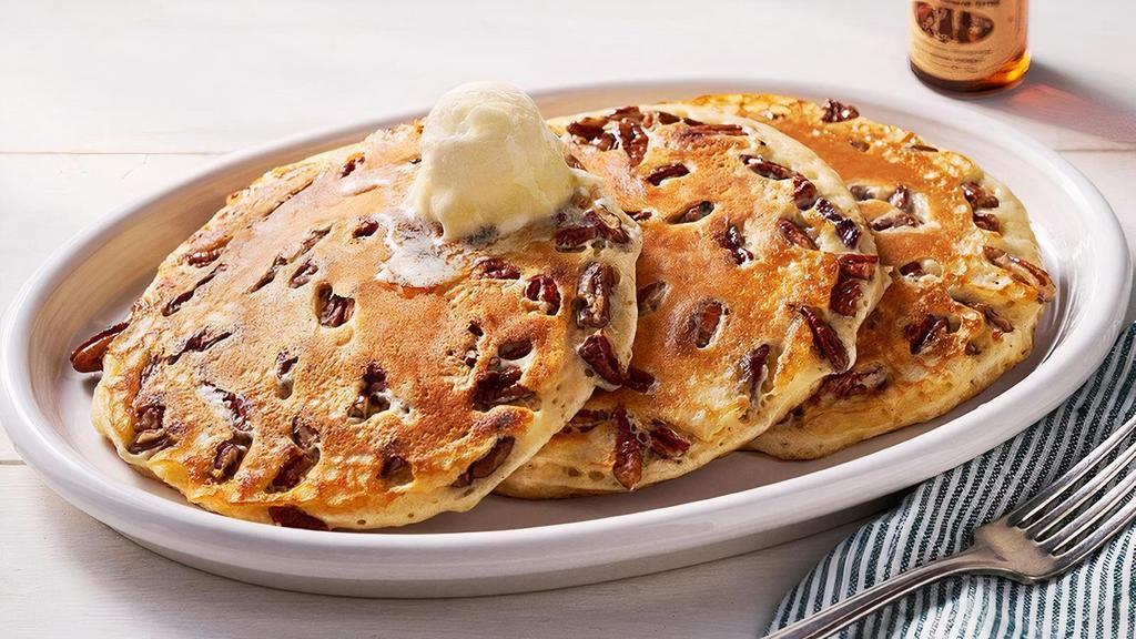 Pecan Pancakes – Three · Three Buttermilk Pancakes n’ butter with pecans.