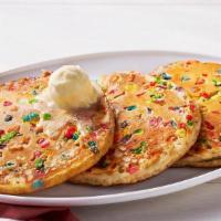 Confetti Pancakes – Three · Three Buttermilk Pancakes mixed with fruity cereal n’ topped with butter