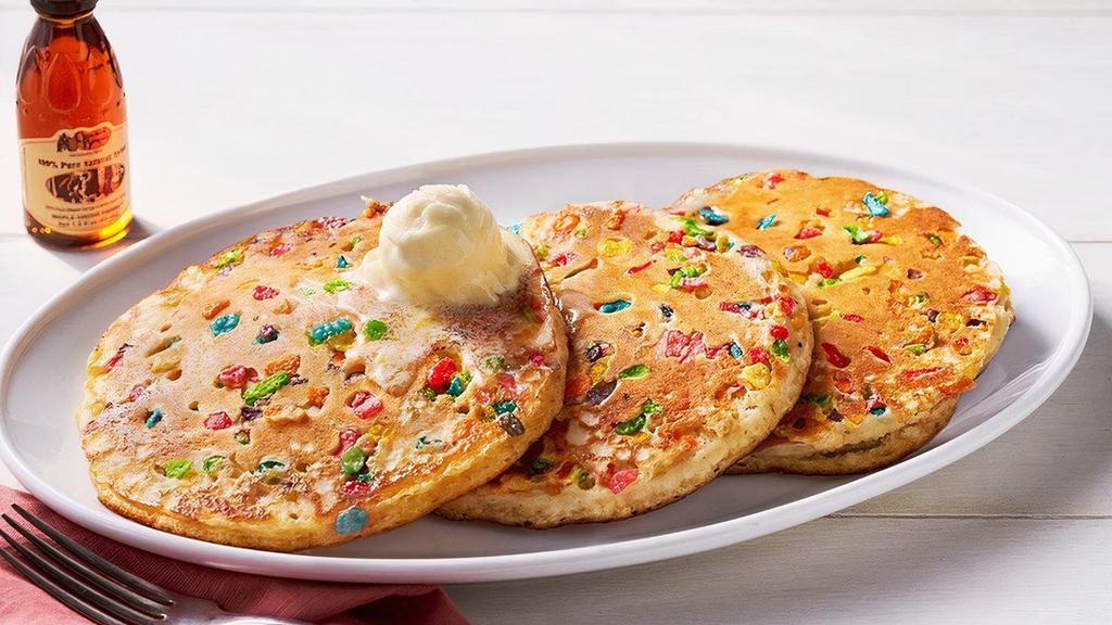 Confetti Pancakes – Three · Three Buttermilk Pancakes mixed with fruity cereal n’ topped with butter