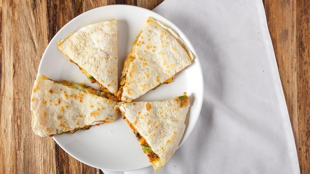 Stuffed Quesadilla  · Grilled ﬂour tortilla stuffed with chicken, bacon, avocado, cheese, pico and a chipotle sauce. Served with sour cream. 1094 cal.