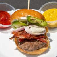 The Kristo · Beef patty, cream cheese spread, raw jalapeño, shallots, and bacon on a brioche bun.