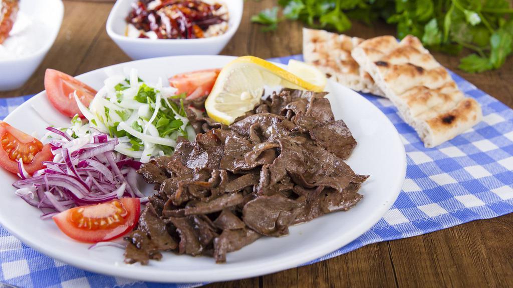 Beef Shawarma Plate · Marinated and flame broiled USDA choice Beef grilled to perfection. Served with customer's choice of side, salad, hummus, garlic sauce, pickles and 2 pieces of pita bread.