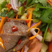 Spicy Beef Salad · Hot. Grilled sliced beef flavored with dry chili, onion, cucumber, tomato, cilantro, and spi...