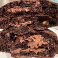 The Nutella Cookie Brazil · Chocolate dough  with semi sweet chocolate and walnuts. 
Filling: Nutella.
Top: Grated Hazel...