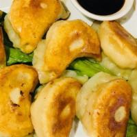 Pot Sticker · Eight pieces. Homemade pan fried dumplings, served with a chef's special sauce and chilli sa...