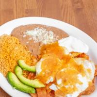 Chilaquiles Rojos · Crispy tortilla chips with red sauce. Two sunny side up eggs on top. Side of Rice, Beans, Ch...
