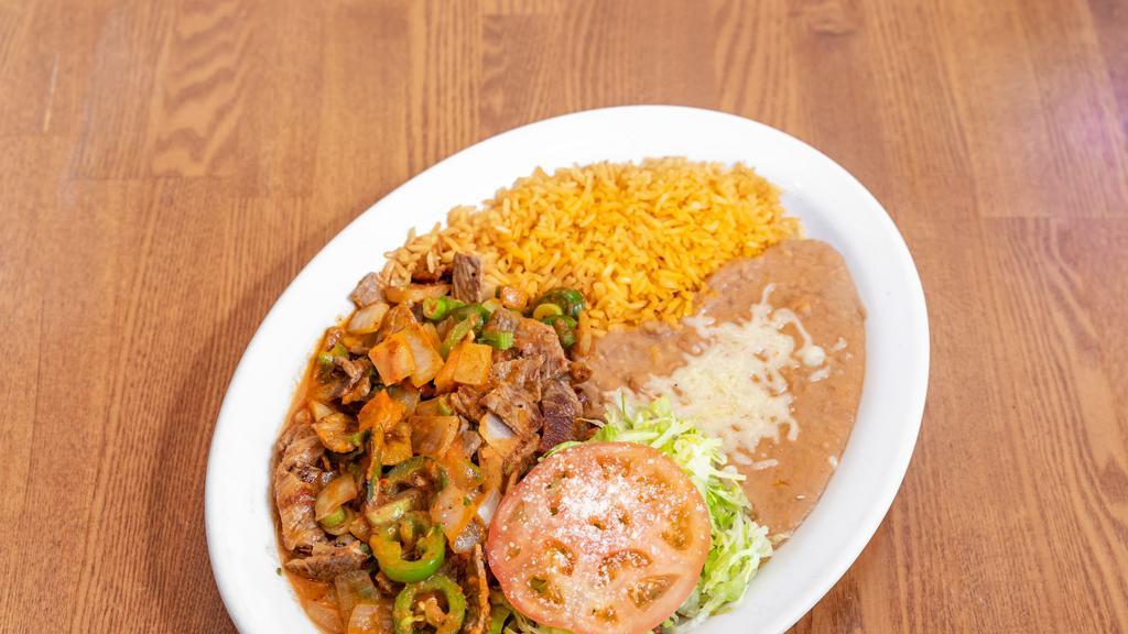 Steak Ranchero · Steak grilled with jalapenos, green onions and tomato  sauce, choice of tortillas
