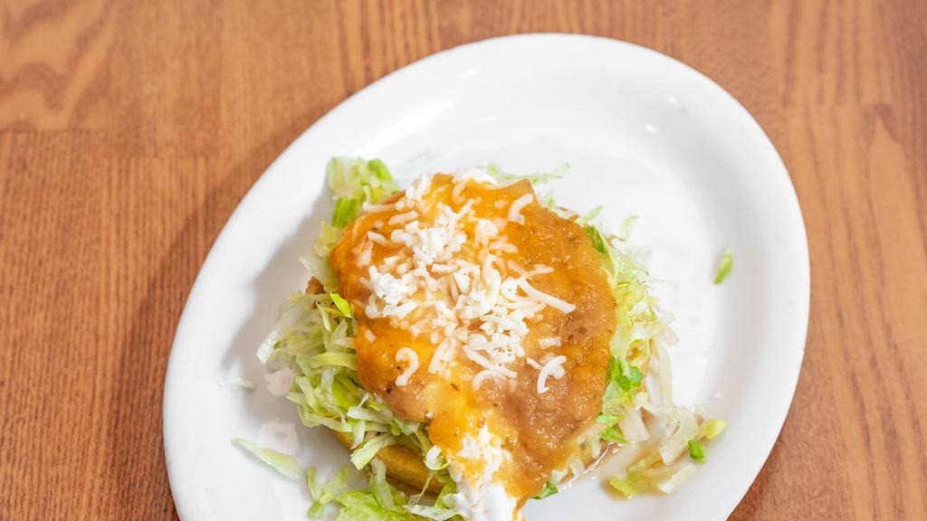 Sopes · A thick and consistent fried corn tortilla with beans, lettuce,sour cream,cheese,salsa and meat of your choice
