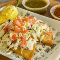 Potato Taco (Each) · Hard shell mashed potato taco topped with cabbage, tomato, house cream, and cotija cheese.