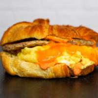 Sausage, Egg And Cheddar Sandwich · 2 fresh cracked cage-free scrambled eggs, melted Cheddar cheese, breakfast sausage, and Srir...