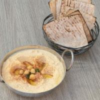 Hummus · Vegetarian. Pureed chickpeas topped with paprika and olive oil. Served with pita bread.