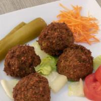 Falafel · Vegetarian. Four pieces of fried vegetarian patties from garbanzo beans and spices. Served w...