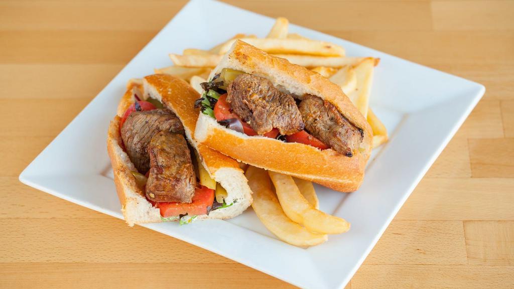 Steak Sandwich · Grilled marinated of filet mignon with lettuce, tomato, onion, pickles, and house dressing. Served in French baguette with a choice of green salad or French fries.