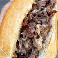 Philly Cheesesteak · Ribeye steak, grilled onions, Provolone or White American cheese on a roll.