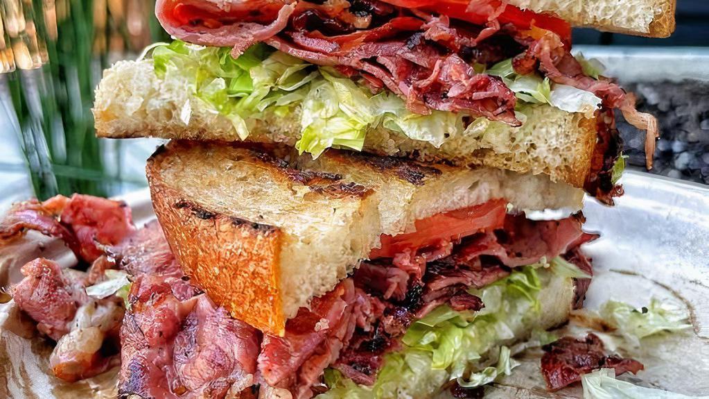 Pastrami Sandwich · Pastrami, lettuce, tomato, mayonnaise & mustard on a sourdough bread.