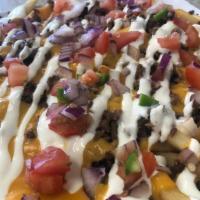 Loaded Fries · Fries loaded with meat : Asada, Cabeza, Al Pastor, Chicken, Carnitas, and Birria, with melte...