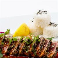 Seared Tuna Steak · tuna tataki coated with sesame seeds, pan‐fried onions, zucchini, red bell pepper, and cilan...