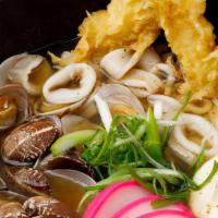 Seafood Nabeyaki Udon · Japanese udon noodle soup, clam, calamari, poached egg, shrimp tempura.