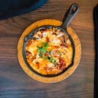 Queso Fundido · Hot melted Monterey jack cheese topped with bell peppers & onions. Served with corn or flour...