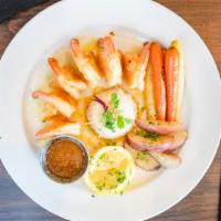 Camarones Al Mojo De Ajo · Shrimp sautéed in a blend of garlic & butter. Served with white rice & vegetables.