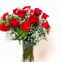 Unforgettable Dozen Rose Arrangement Red  · Dozen red roses with babies breath and greens arranged in clear vase.
