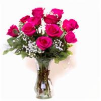 Unforgettable Dozen Rose Arrangement Pink  · Dozen pink roses with babies breath and greens arranged in clear vase.