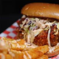 Sandwich And Fries · Large Nashville-style boneless chicken breast fried to perfection topped with coleslaw, pick...