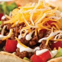 Taco Salad · Served in a large taco shell, ground beef, shredded lettuce, tomato, shredded jack/cheddar c...