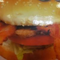 1/4 Lb. Bacon Burger · Made with 1000 Island dressing, onions, lettuce, tomato and pickles on a white sesame bun.
