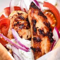 Souvlaki Sandwich · Chicken OR Steak, diced white onions, diced tomatoes, and cucumber sauce (tzaziki) in warm p...