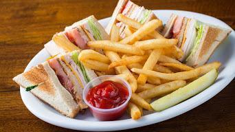 Club Sandwich With Fries · Triple decker sandwich, with thin turkey, thin ham,  bacon, lettuce, tomato, mayo on white b...