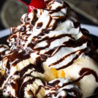 Cookie Monster · Baked cookie skillet, vanilla ice cream, whipped cream, chocolate syrup.