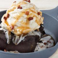 Brownie Obsession · A fudge brownie, vanilla bean ice cream, caramel sauce & glazed pecans.
