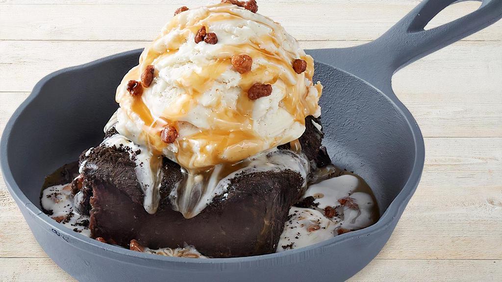 Brownie Obsession · A fudge brownie, vanilla bean ice cream, caramel sauce & glazed pecans.