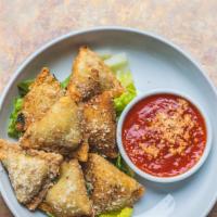 Fried Raviolis · Filled with spinach and cheese, served with spicy marinara.