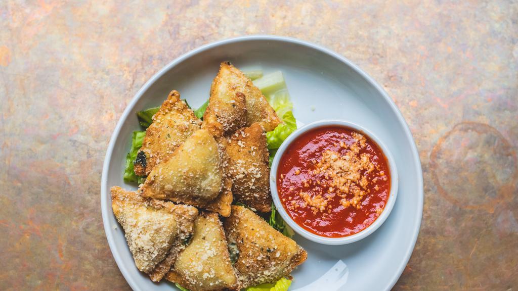 Fried Raviolis · Filled with spinach and cheese, served with spicy marinara.