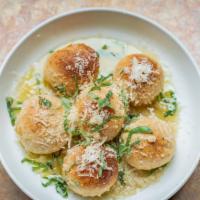 Bocce Balls · Lightly fried balls of pizza dough smothered in garlic butter, parmesan and basil.