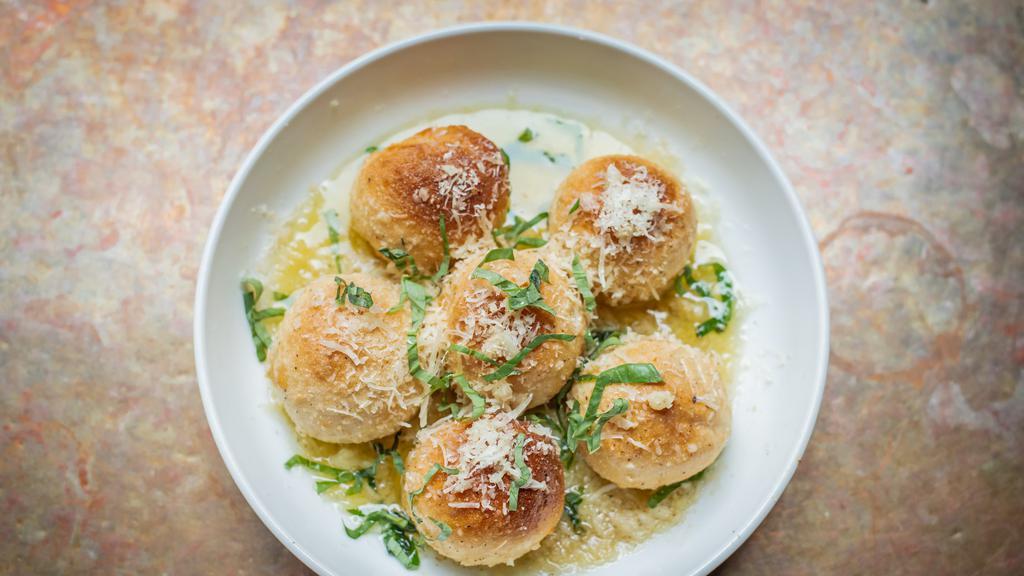 Bocce Balls · Lightly fried balls of pizza dough smothered in garlic butter, parmesan and basil.