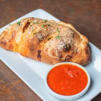 Meatball Calzone · Three house made meatballs smothered in marinara and mozzarella cheese, wrapped in pizza dou...