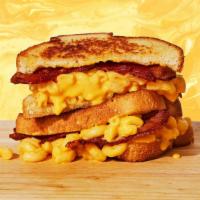Mac Attack Grilled Cheese · Creamy classic mac and cheese with crispy bacon on two slices of buttery grilled bread.